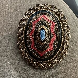 Sarah Coventry Gold and Black Brooch with Red and Blue Accents